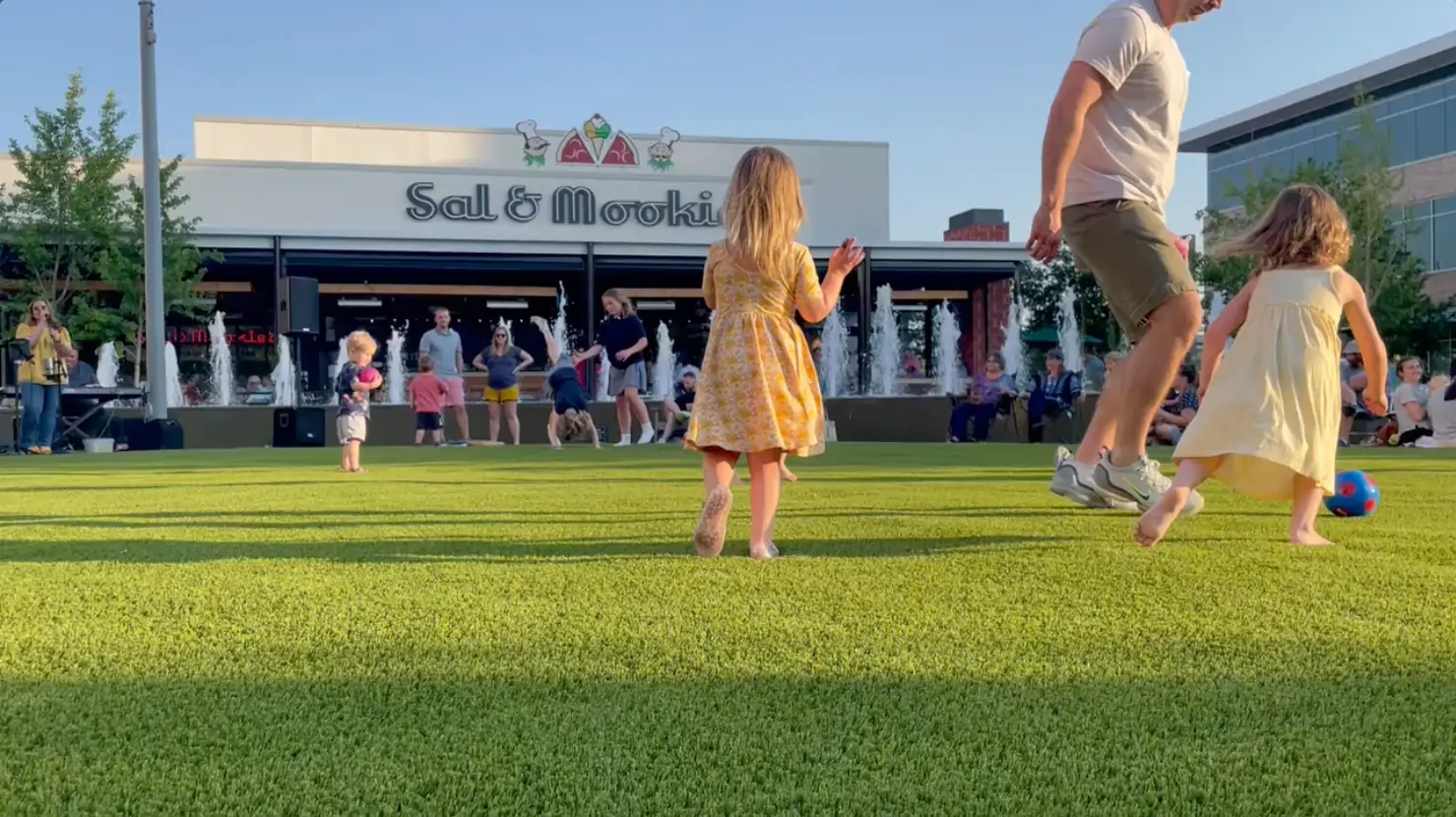 Kids playing on artificial grass installed by SYNLawn